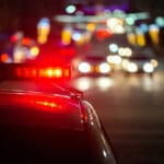 police car lights at night in city with selective focus and bokeh background blur